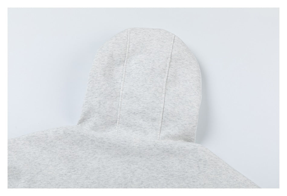 Close-up of a light gray heathered garment hood with visible panel seams.