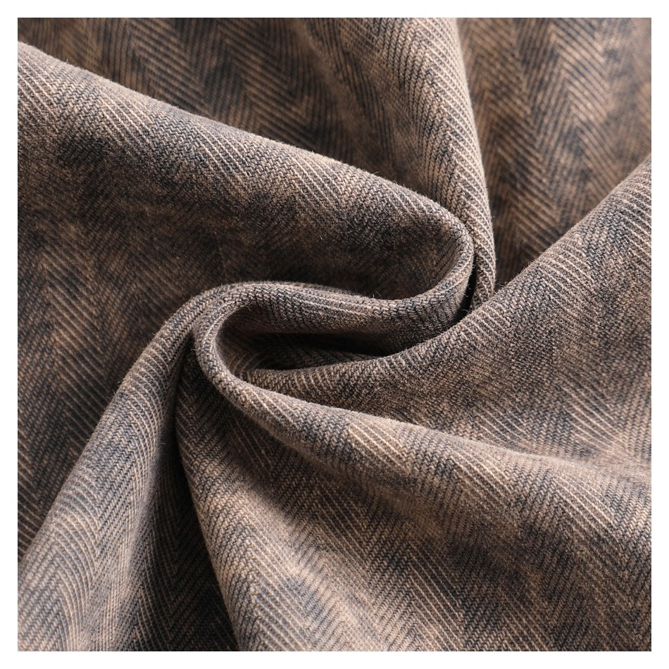 Close-up of draped brown and gray herringbone-patterned fabric.