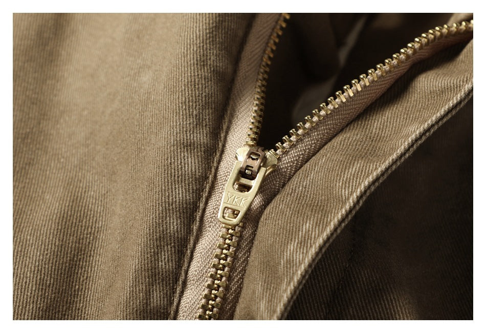 Close-up of the pants' brass-colored zipper and YKK zipper pull.
