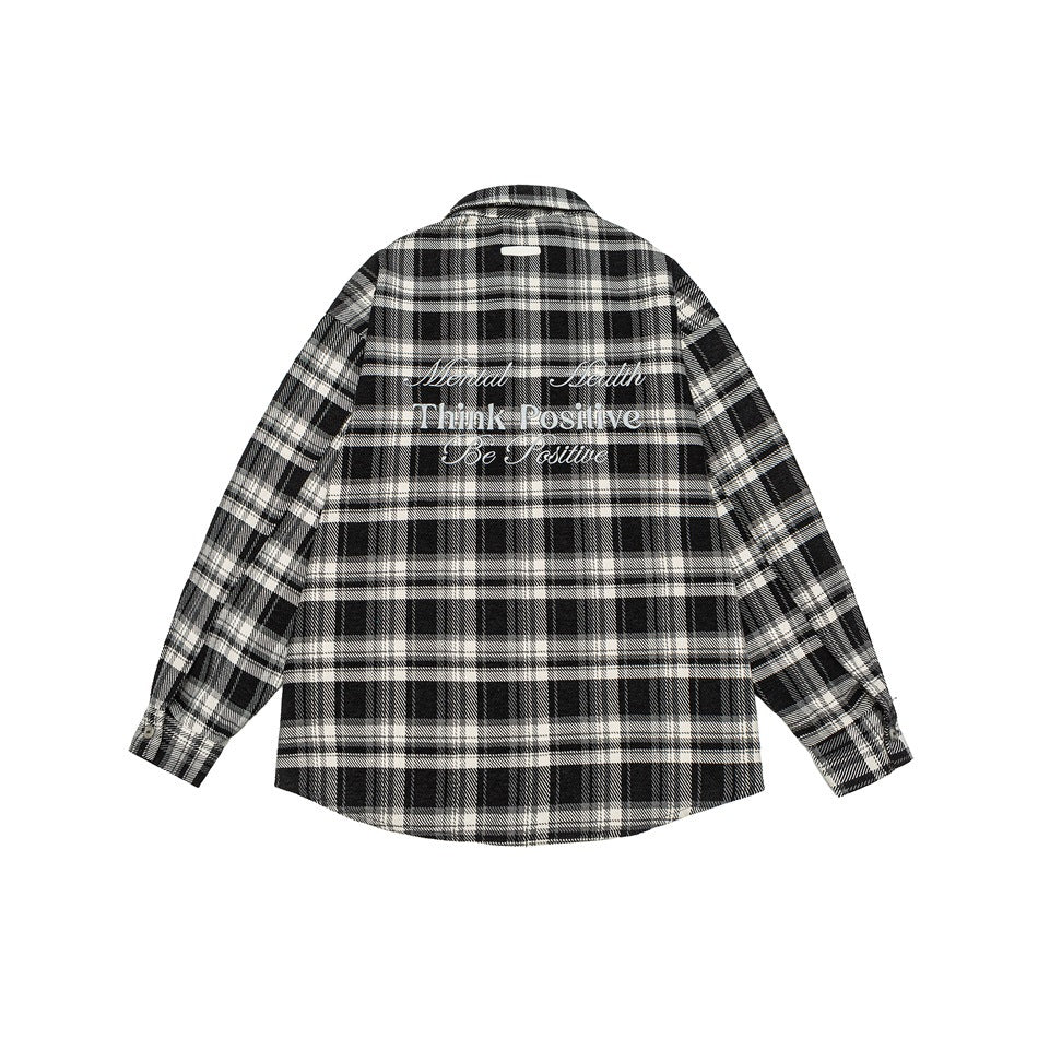 Back view of black and white plaid long-sleeve shirt with embroidered Think Positive lettering