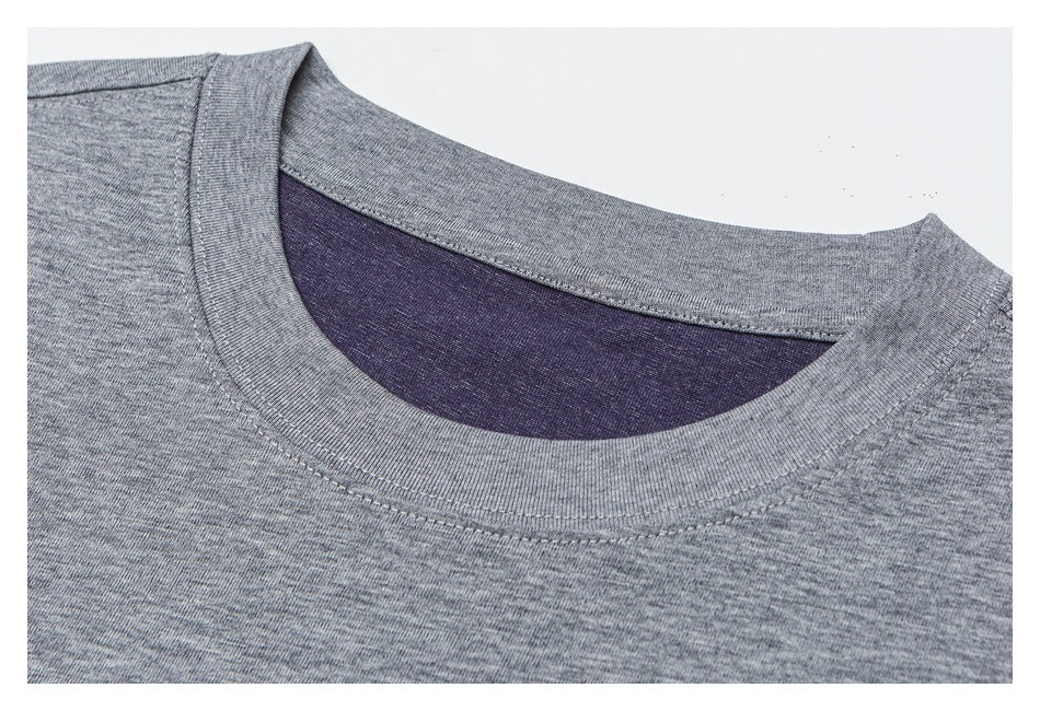 Close-up of a heather-gray crew-neck shirt with a dark purple inner neckline.
