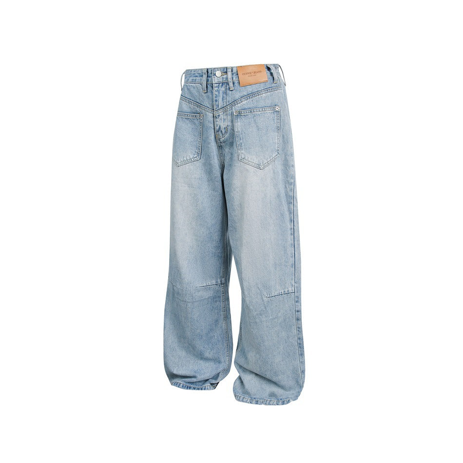 Back view of light-wash, wide-leg jeans with two large patch pockets and a tan waistband label.