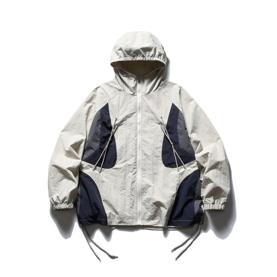 Off-white hooded jacket with a white front zipper, navy and gray panels, drawcord pockets, elastic cuffs, and hem cords.