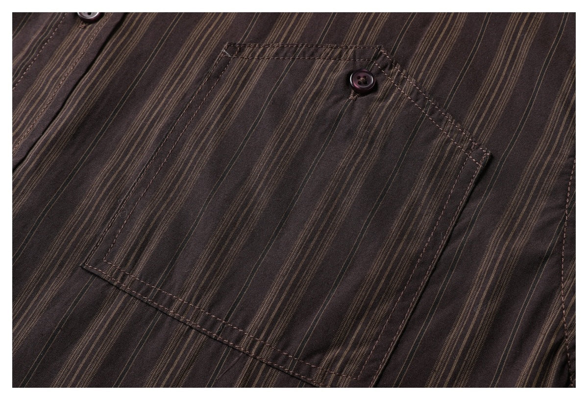 Close-up of a rectangular chest pocket and dark button on the dark brown, tan-striped shirt.