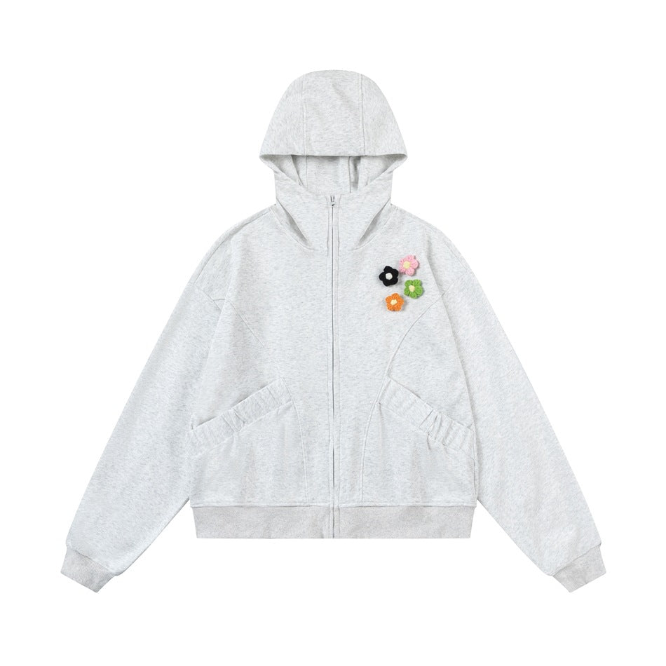 Heather gray zip-up hoodie flat lay with four small flower appliques on the chest and ribbed cuffs and hem