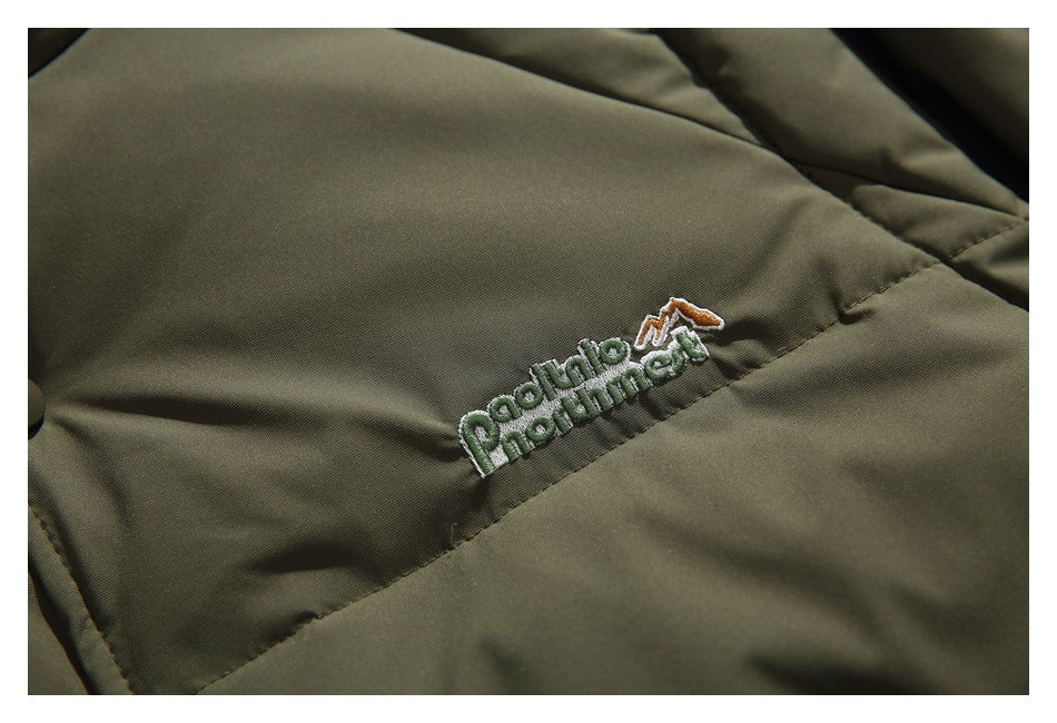 Close-up of an embroidered English-language logo on the olive quilted jacket chest.