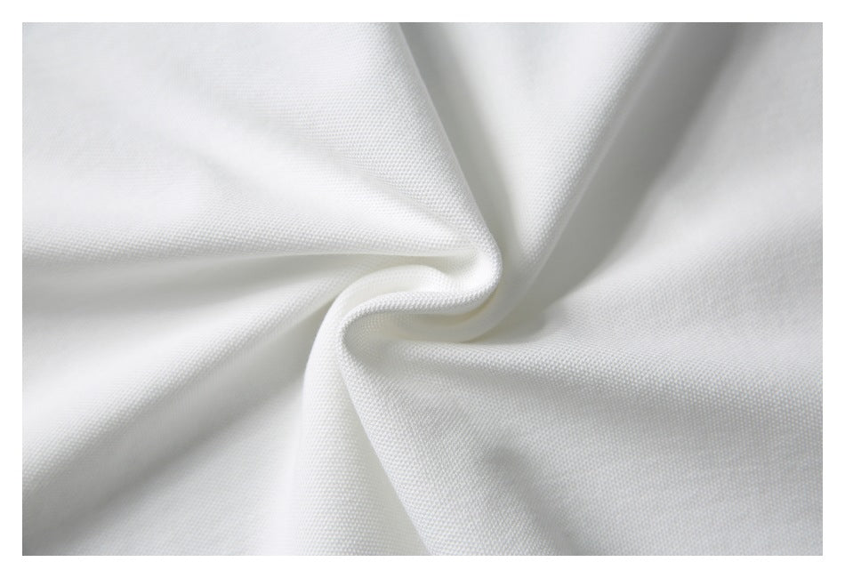 Close-up of white textured fabric gathered into soft folds.