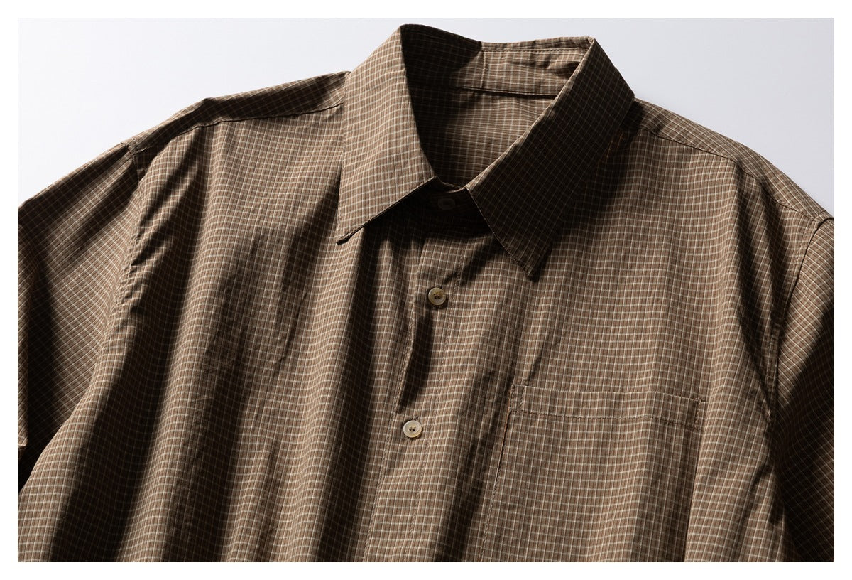 Brown plaid button-up shirt shown from the front, with long sleeves and a chest pocket.