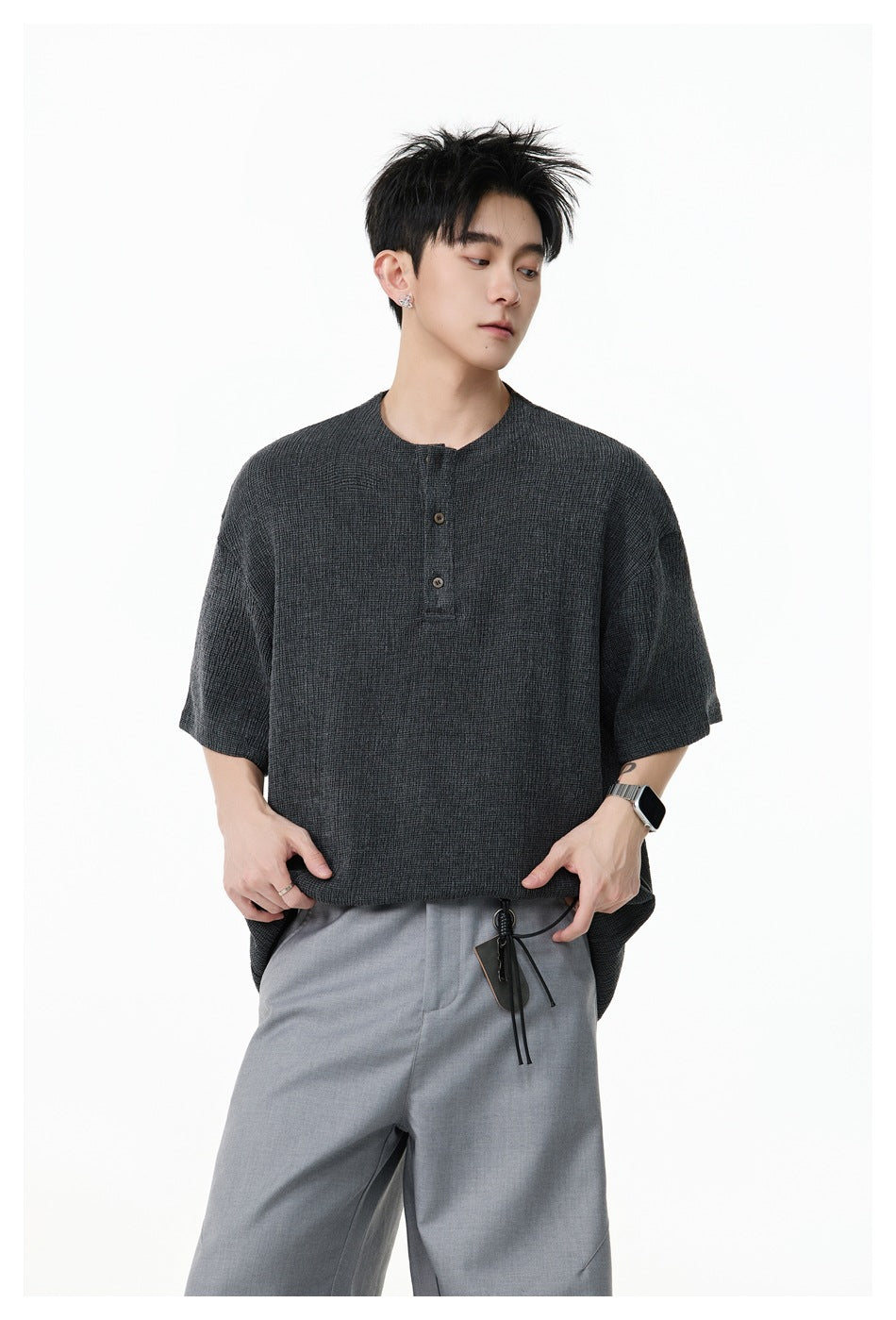 Closer view of a model wearing a charcoal textured short-sleeve top with a two-button placket.