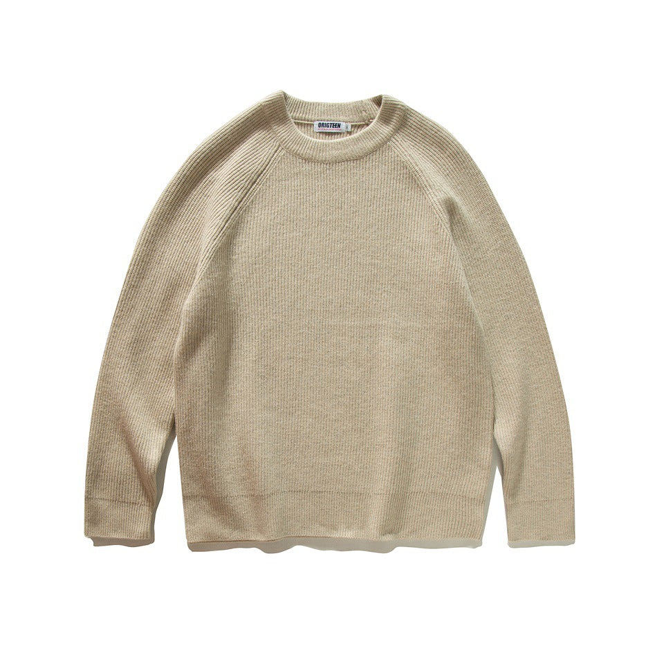 Front view of a beige rib-knit crew-neck sweater with raglan sleeves, laid flat.