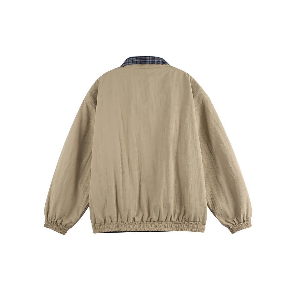 Back view of khaki jacket with plaid collar lining visible and elastic cuffs and hem