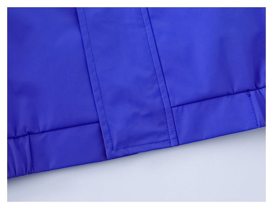Close-up of a vivid blue garment hem with a stitched front placket.