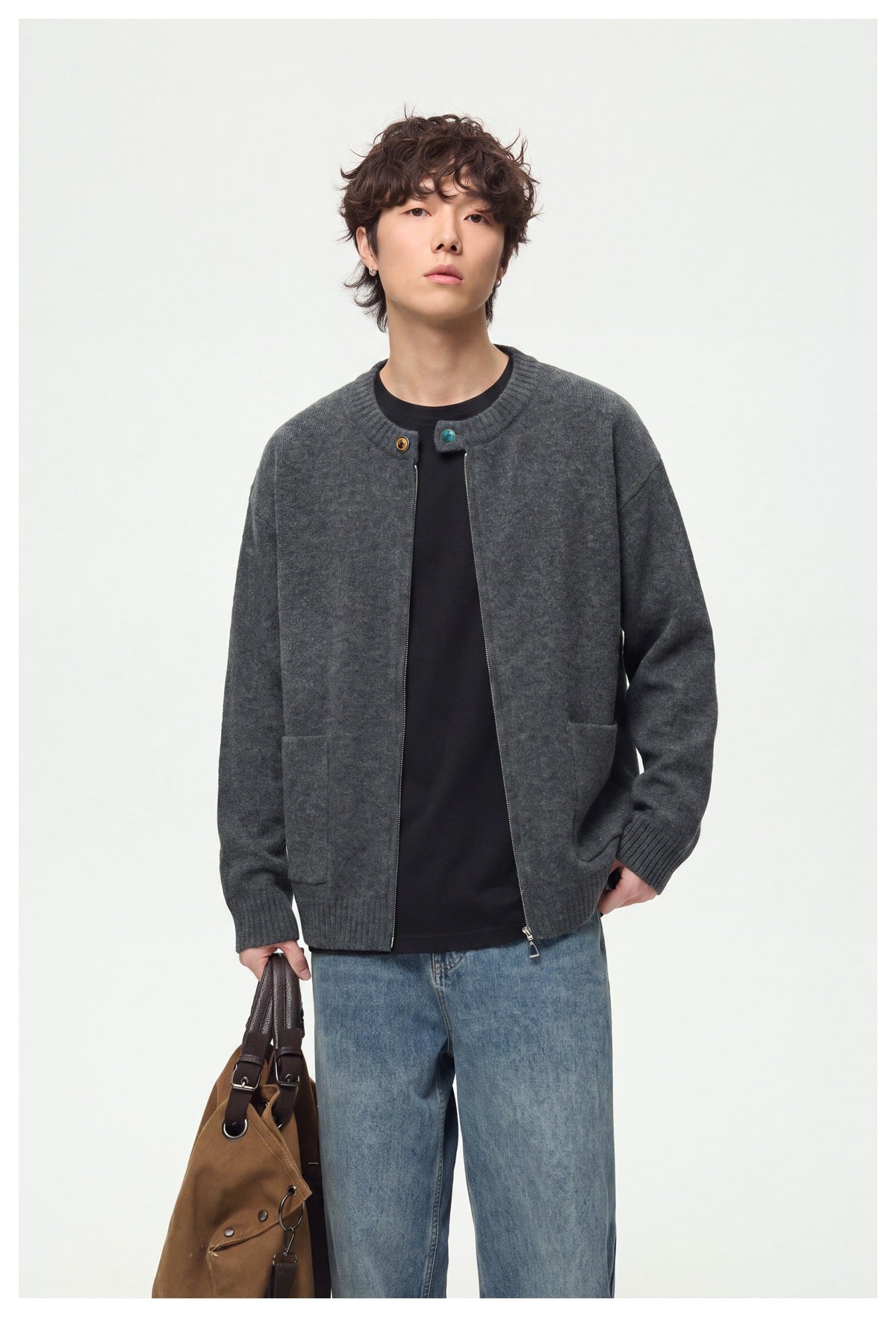 Model wearing an open charcoal gray cardigan with ribbed cuffs and hem, styled with jeans and a brown bag.