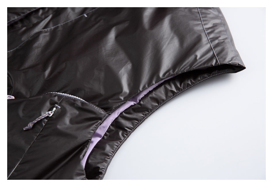 Close-up of a black jacket edge with lavender lining and visible stitching.