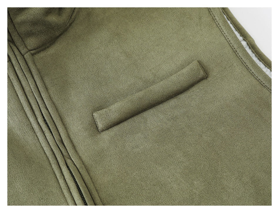 Close-up of the olive vest's chest welt pocket and front zipper.