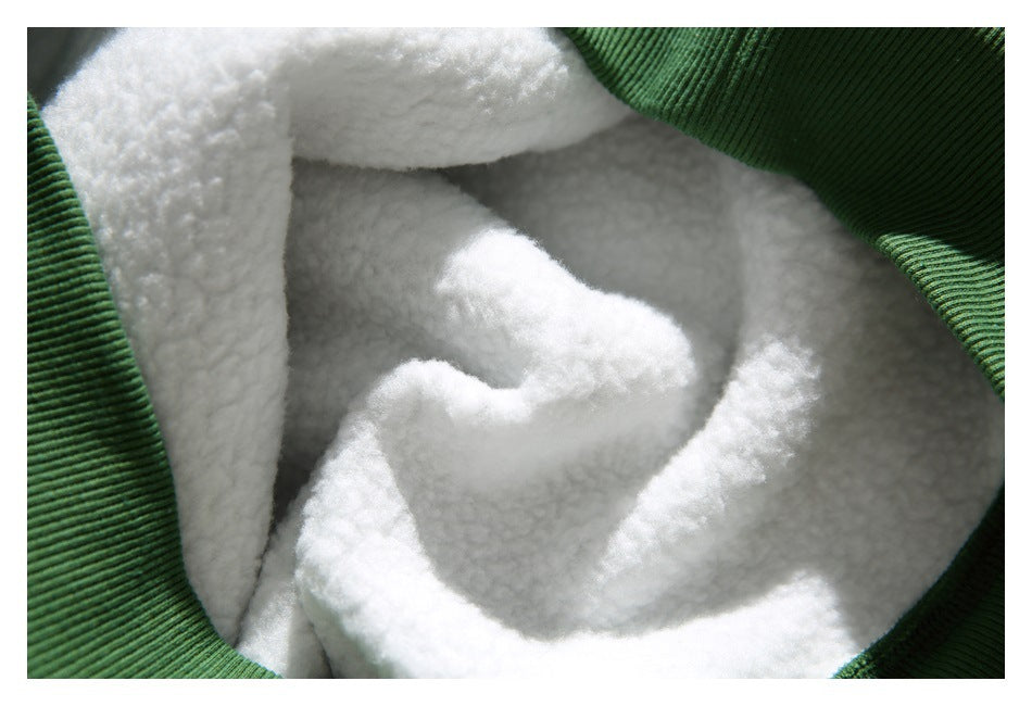 Close-up of the white plush lining inside a green sweatshirt.