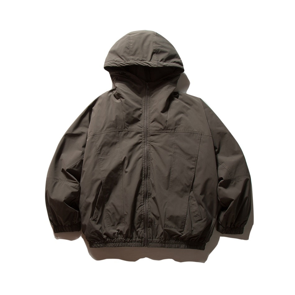 Dark gray hooded zip-up jacket flat lay, front view, with paneled seams, pockets and elastic cuffs and hem