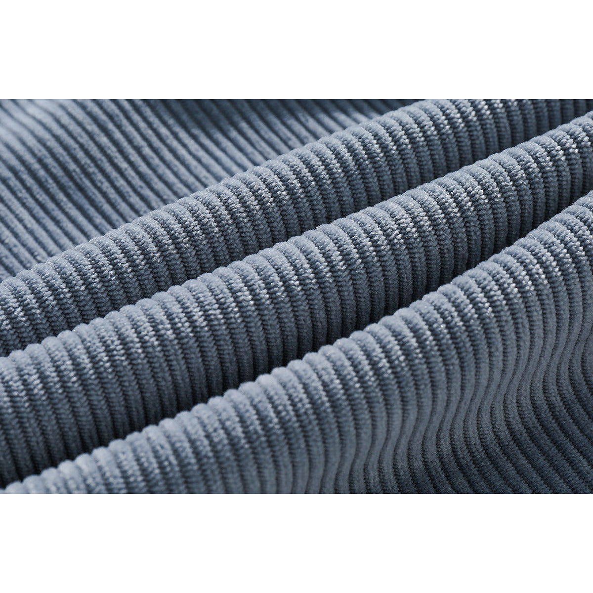 Extreme close-up showing the ribbed texture of blue corduroy fabric.