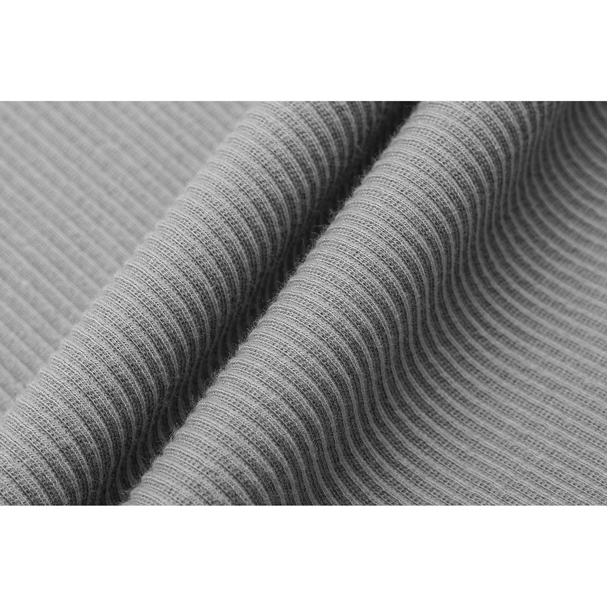 Close-up showing the fine ribbed texture of gray knit fabric.