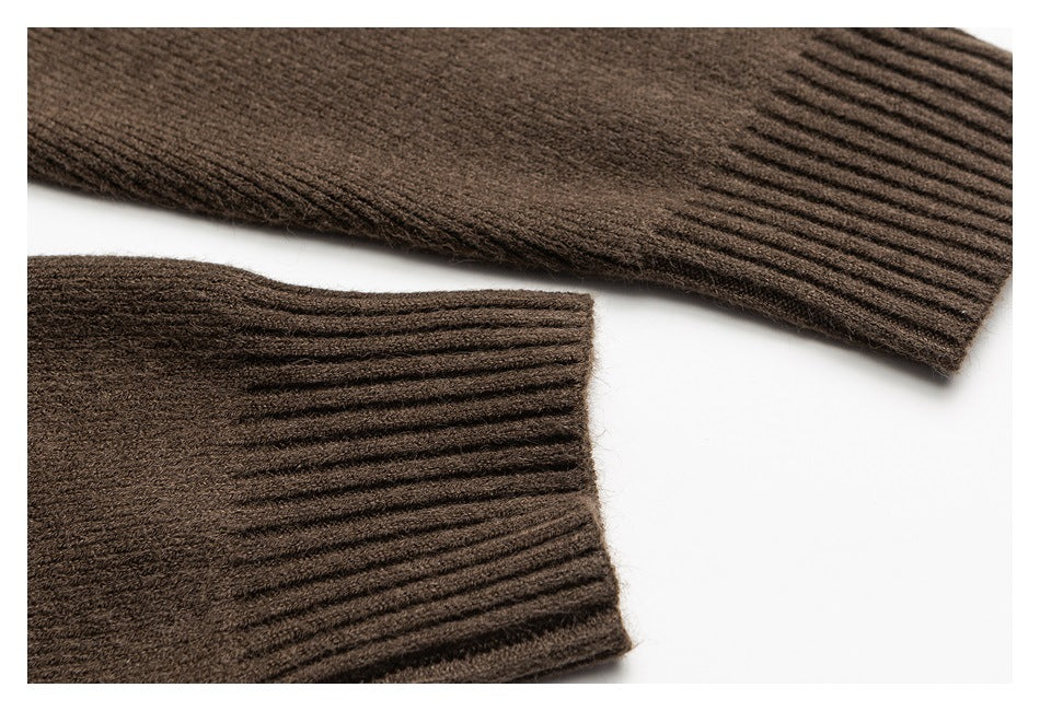 Close-up of two brown ribbed knit sleeve cuffs laid on a white background.