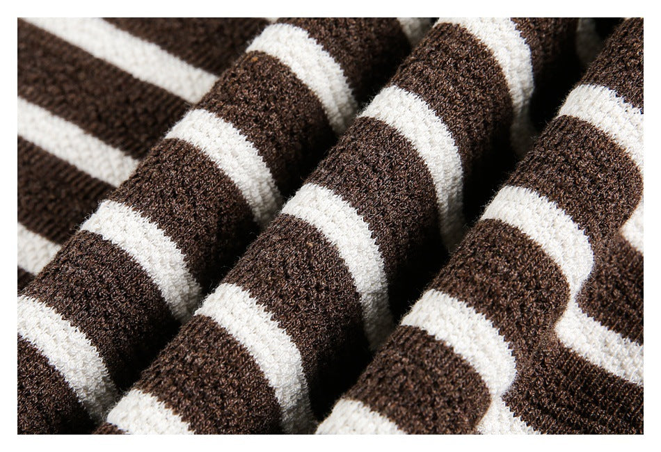 Close-up of brown and white striped knitted fabric with a visible textured weave.
