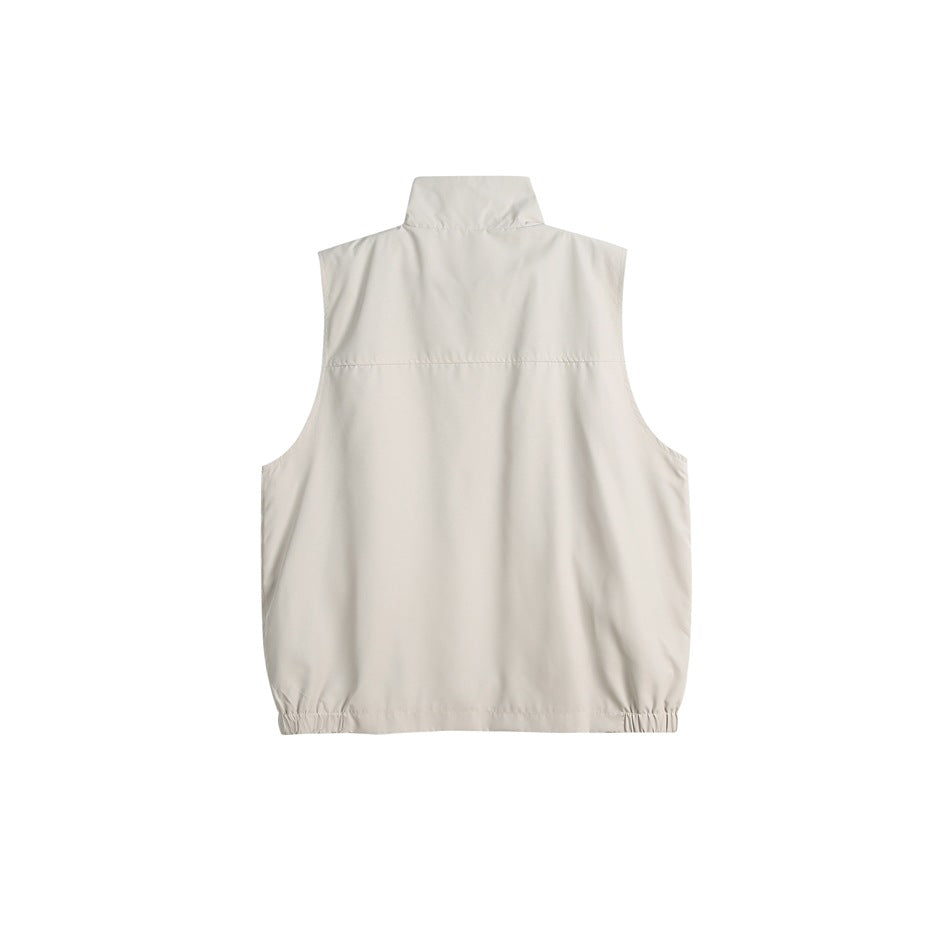 Back view of an off-white sleeveless vest with a stand collar, back yoke seam and gathered hem.