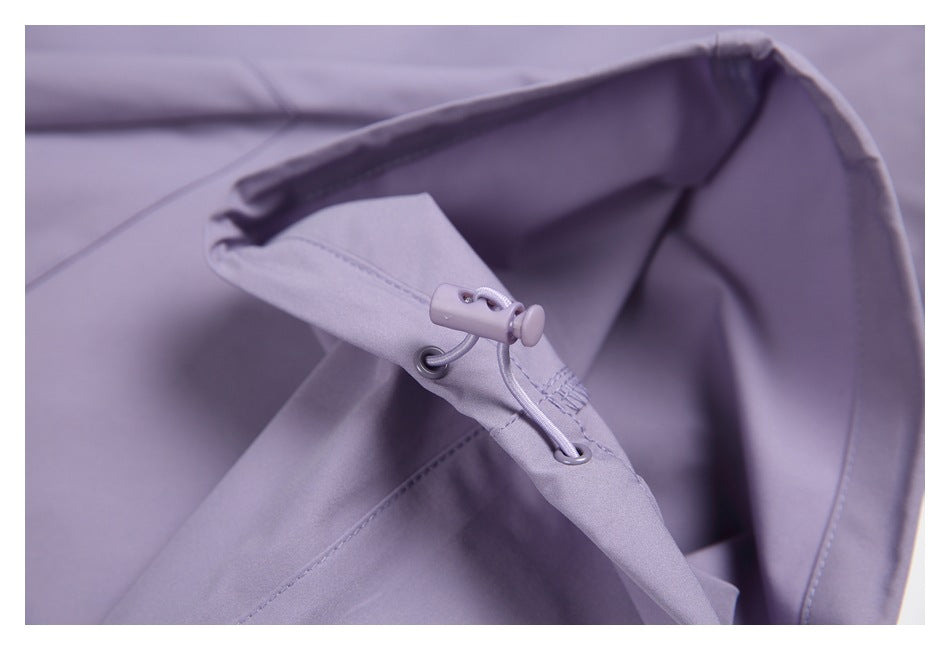 Close-up of a lavender trouser cuff with an adjustable drawcord and stopper.