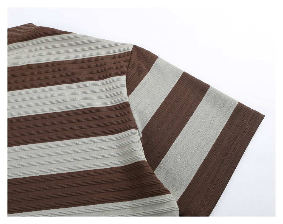 Close-up of the striped shirt’s shoulder and short sleeve, showing alternating brown and light gray bands.