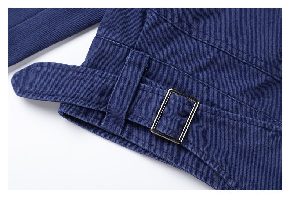 Close-up of the navy jacket's waist tab and rectangular metal buckle.