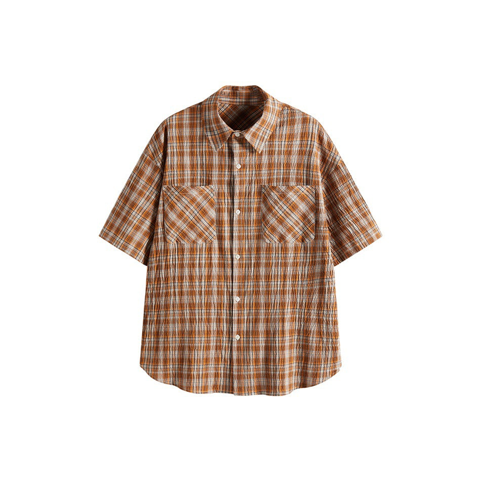 Orange plaid short-sleeve button-up shirt, front view, with two chest patch pockets and a crinkled texture