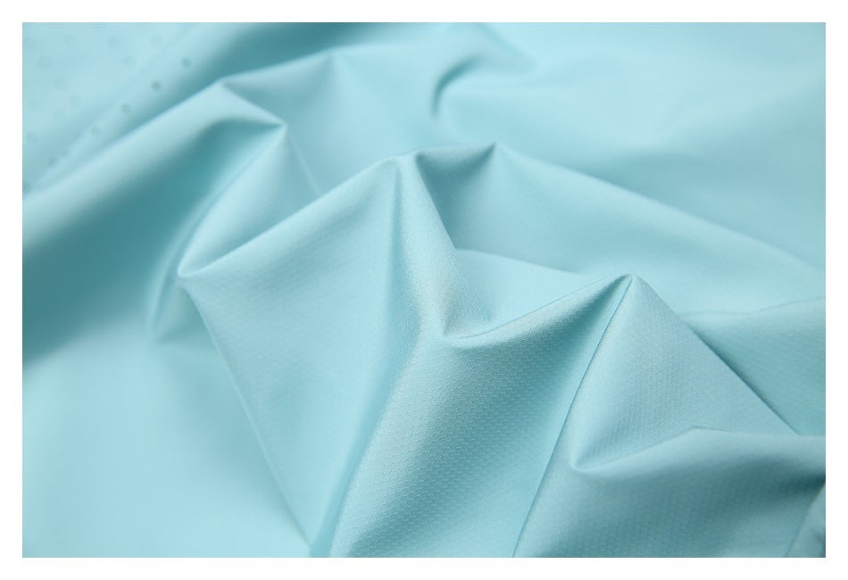 Close-up of pale aqua fabric showing its fine textured surface and folds.