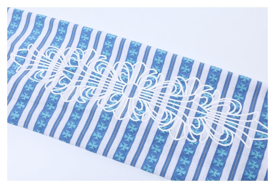 Close-up of a blue-and-white striped garment panel with a large white ornamental graphic.
