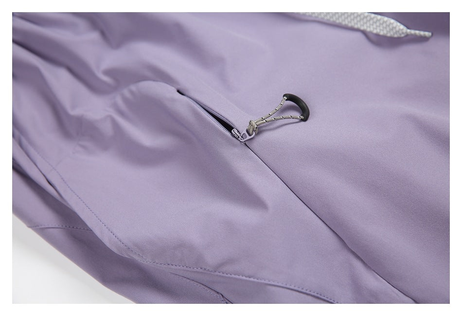 Close-up of a zip pocket with a black cord loop on lavender trousers.