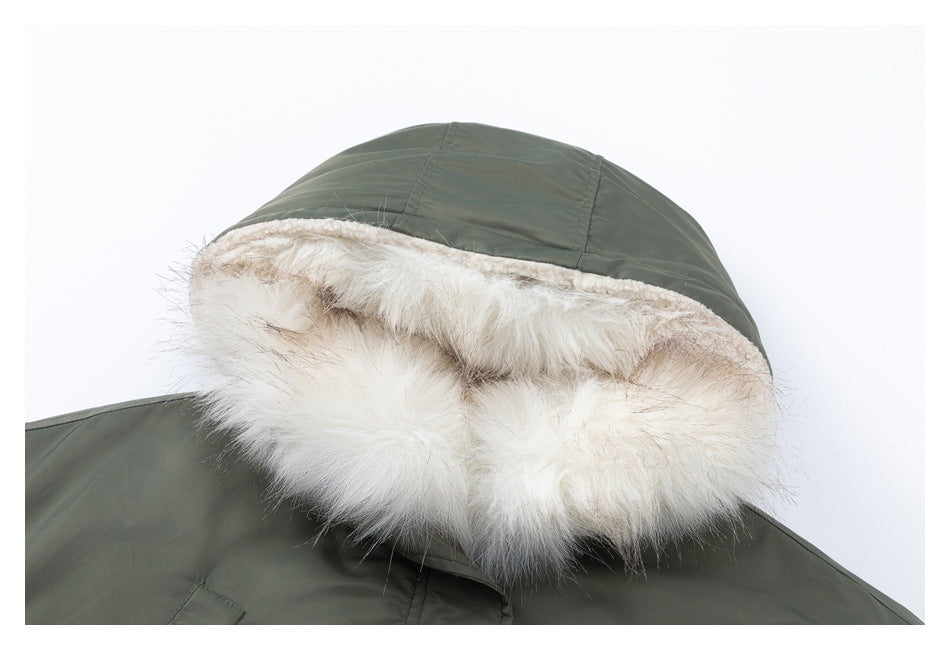 Close-up of an olive-green jacket hood with thick cream faux-fur trim.