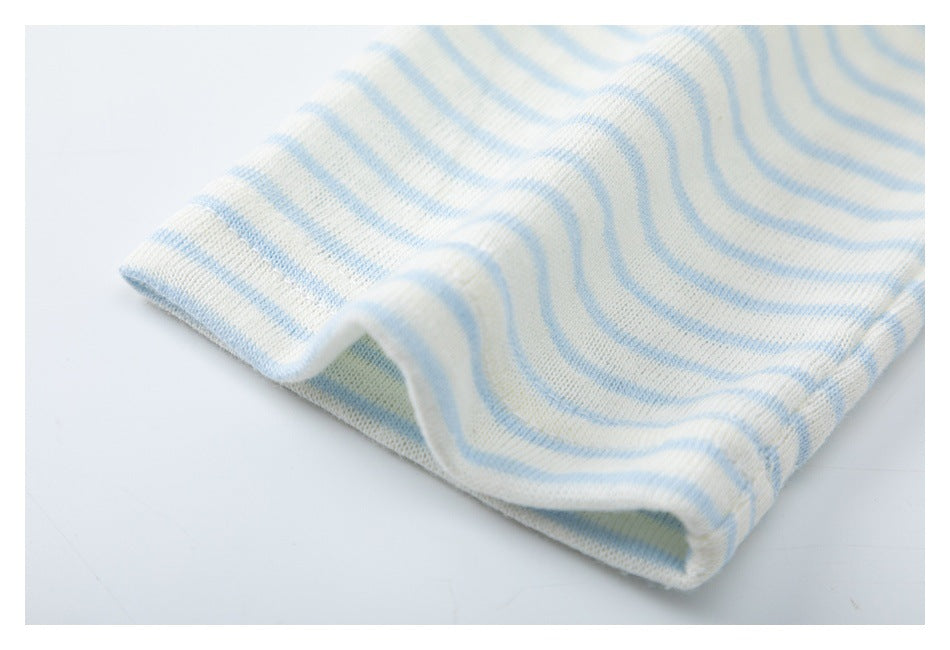 Close-up of a folded edge of pale blue and white striped knit fabric.