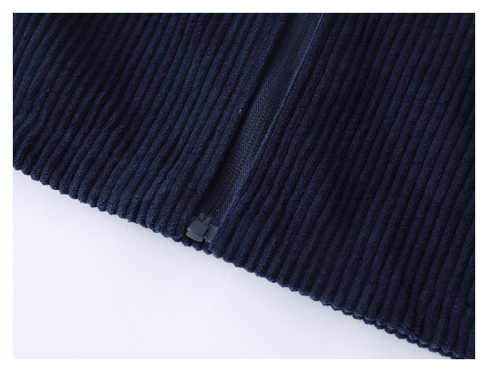 Close-up of a zipper at the ribbed edge of a dark navy garment.