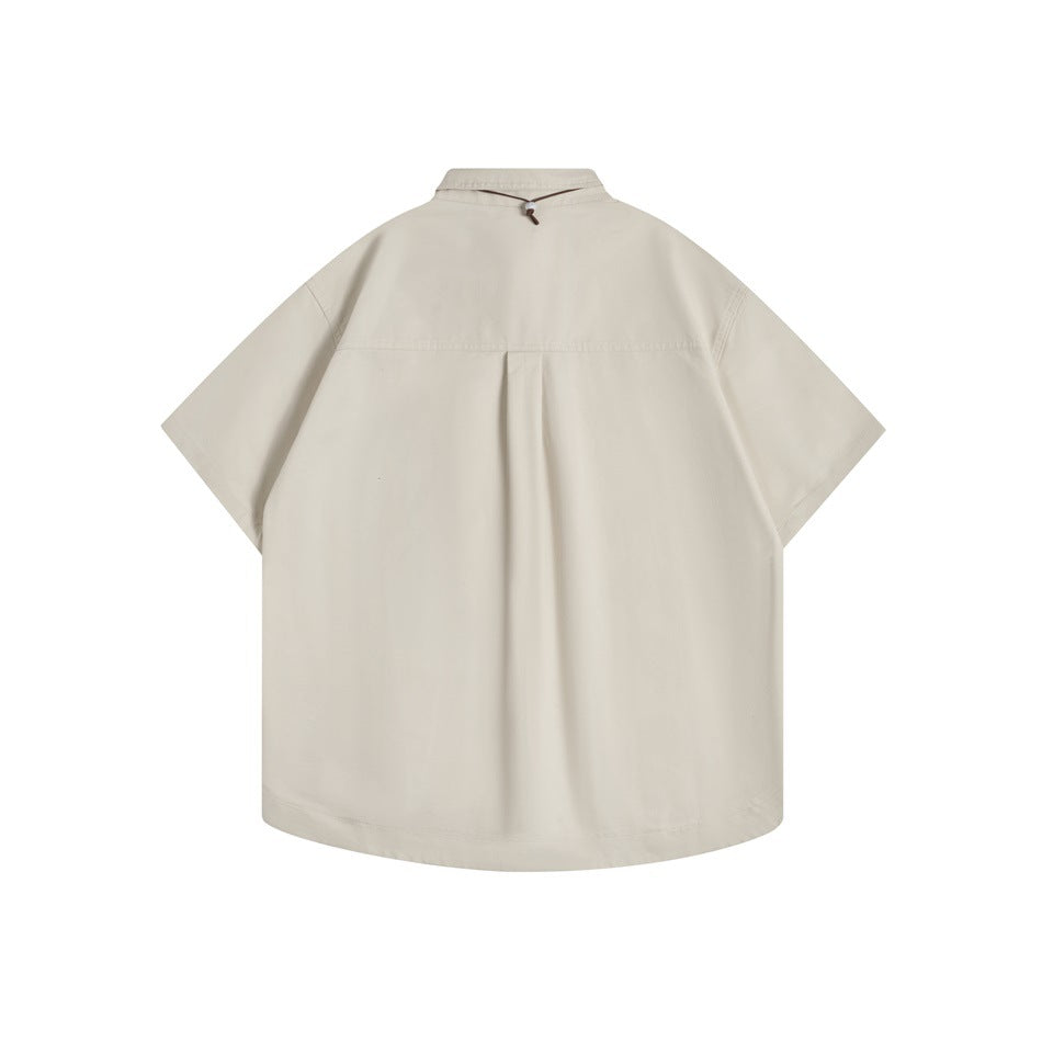 Khaki short-sleeve shirt, back flat lay, showing back yoke seam and center pleat