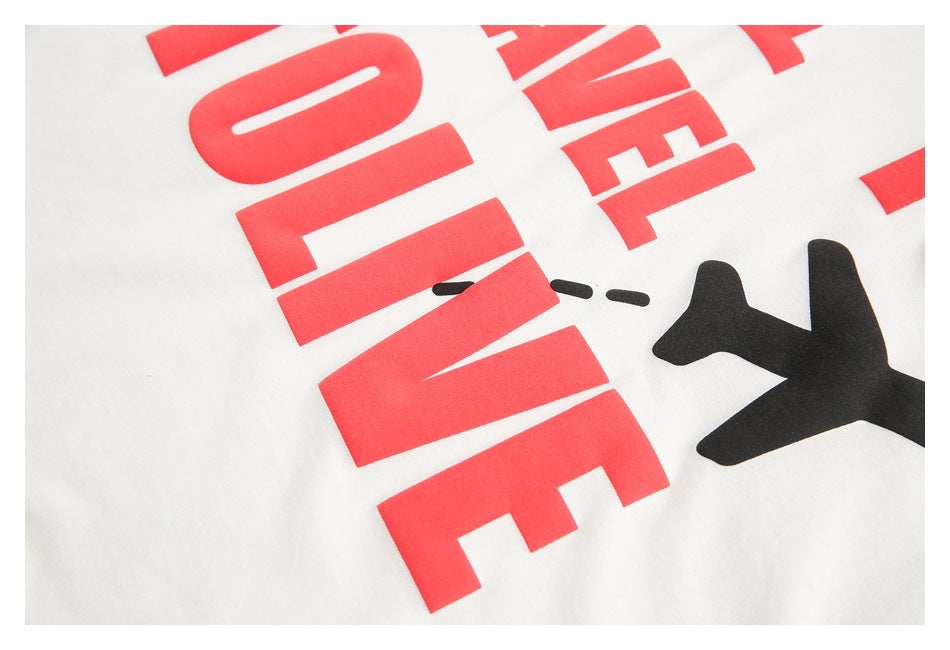 Close-up of red lettering and part of a black airplane graphic printed on white fabric.