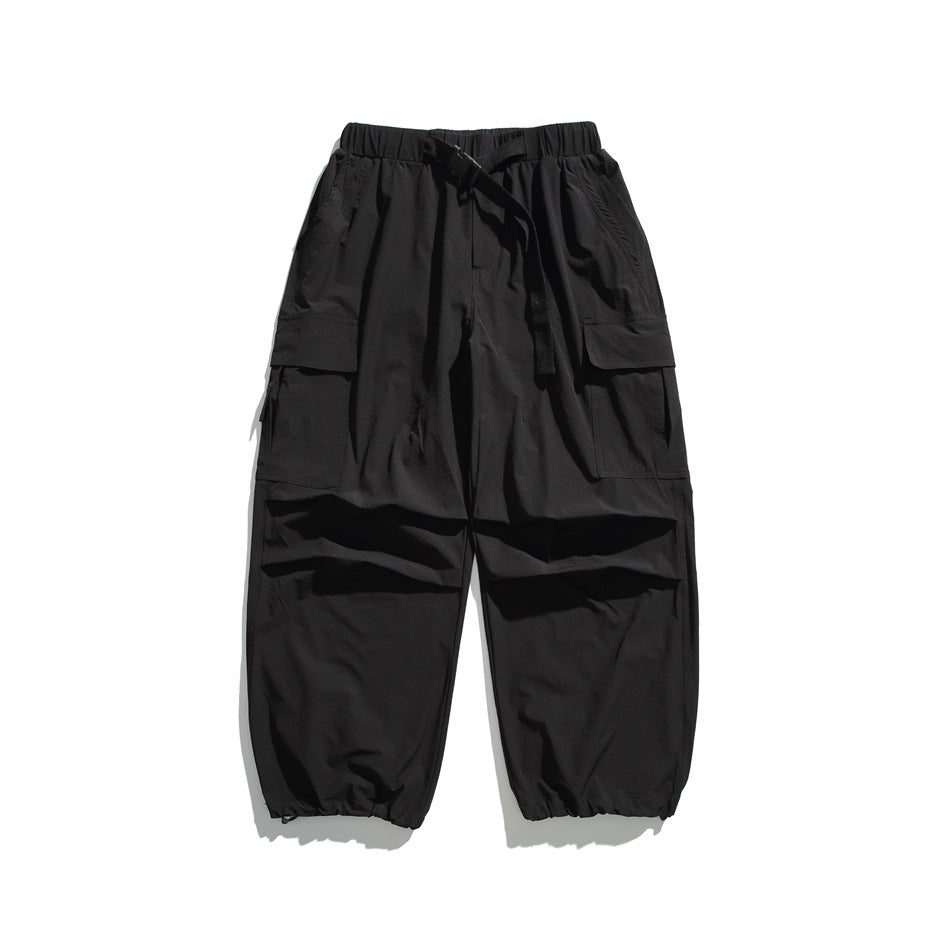 Black wide-leg cargo pants flat lay with elastic waist, belt, side flap pockets and gathered ankle hems