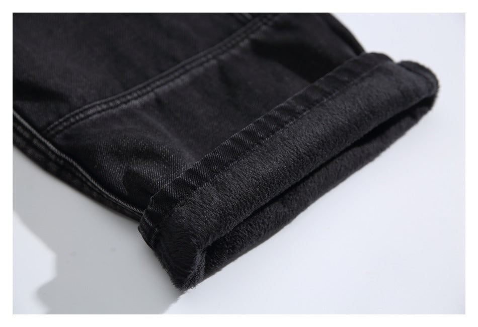 Close-up of a black jeans cuff turned back to reveal a soft dark lining.