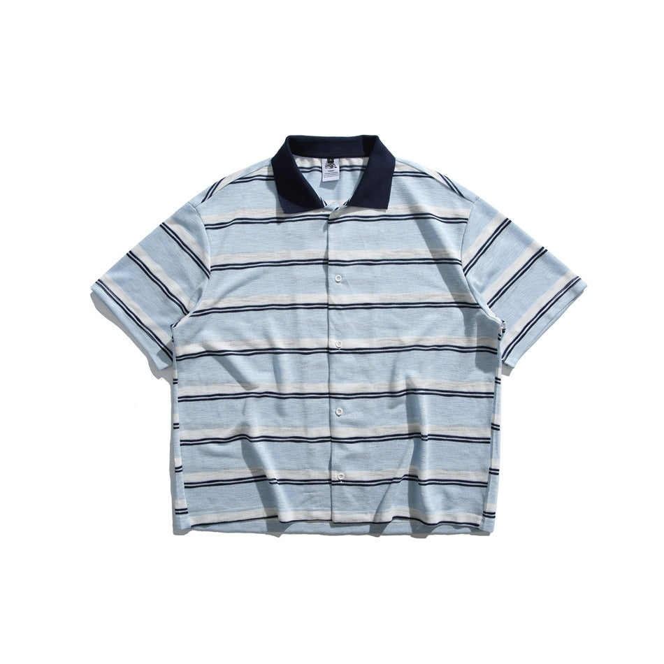 Light blue shirt with white and navy horizontal stripes, navy collar and white buttons, laid flat, front view