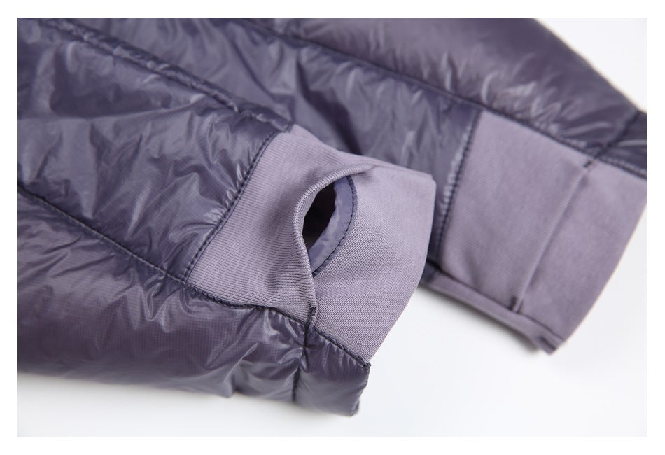 Close-up of a dark purple jacket sleeve with a ribbed cuff and thumb opening.