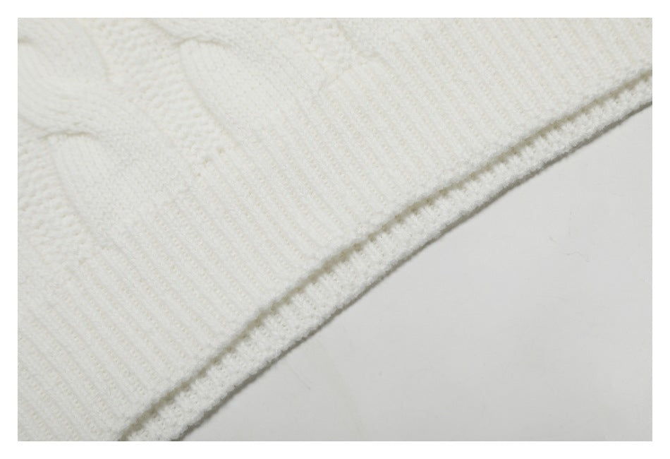 Close-up of white ribbed knit fabric and a narrow finished edge.