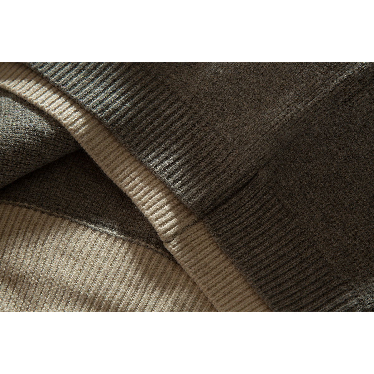Close-up of gray knit fabric and cream ribbed trim on the cardigan.