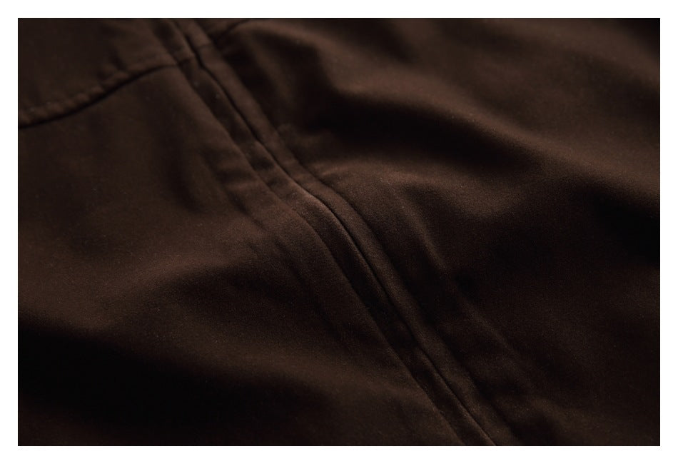 Close-up of dark brown fabric and parallel stitched seams.