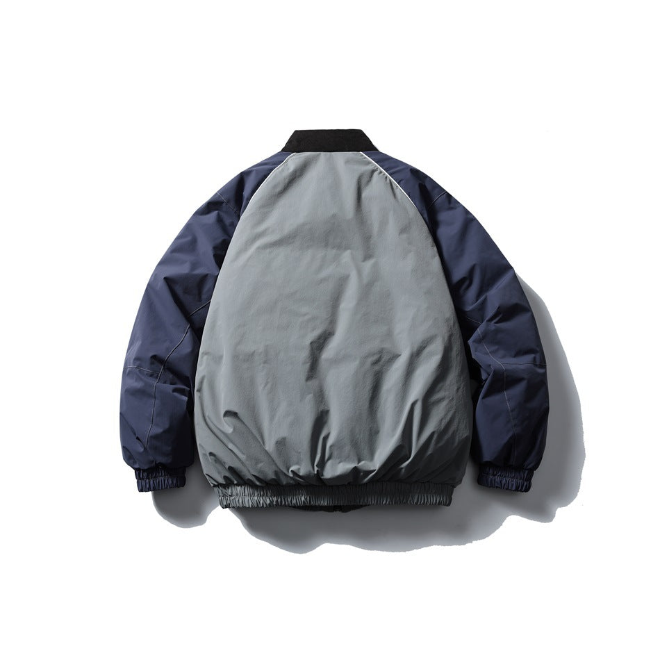 Back view of gray and navy color-block jacket with black collar, navy raglan sleeves and elastic hem