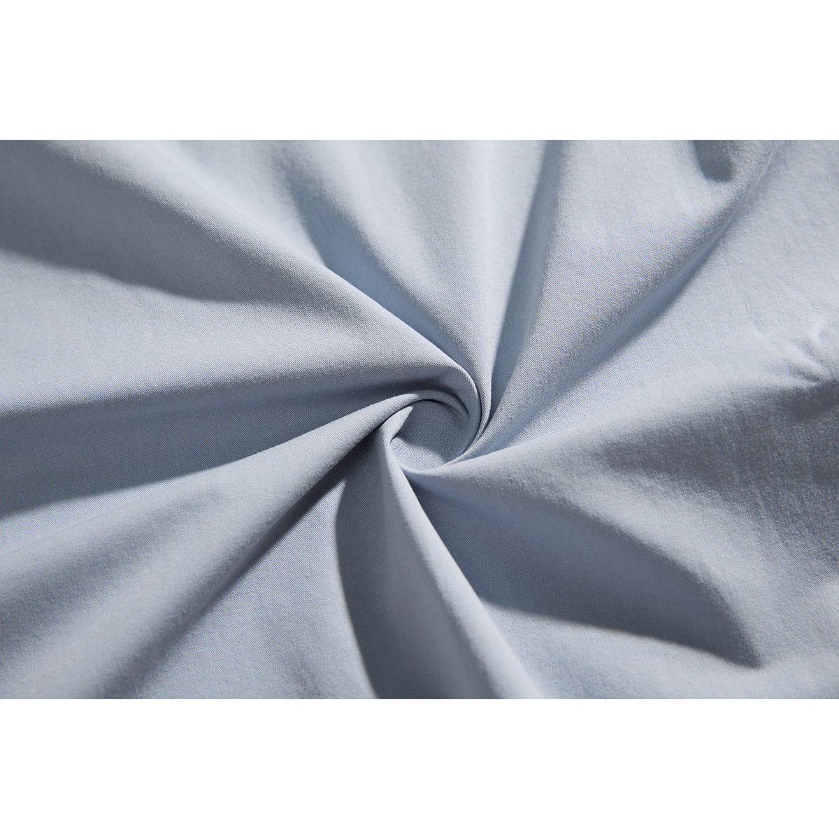 Close-up of light blue-gray fabric gathered into folds.
