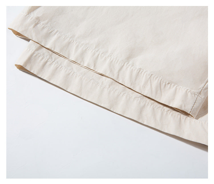 Close-up of the off-white shirt's double-stitched bottom hem.