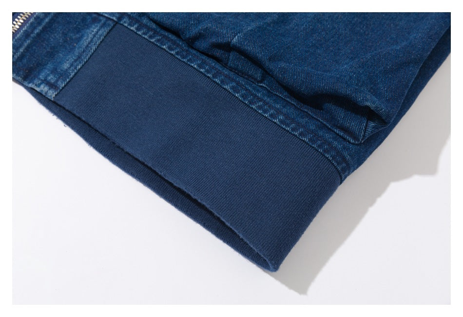 Close-up of a dark blue ribbed waistband on a denim jacket.