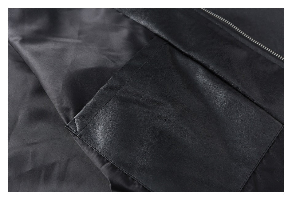 Close-up of a black jacket interior with a lining, stitched pocket, and zipper edge.